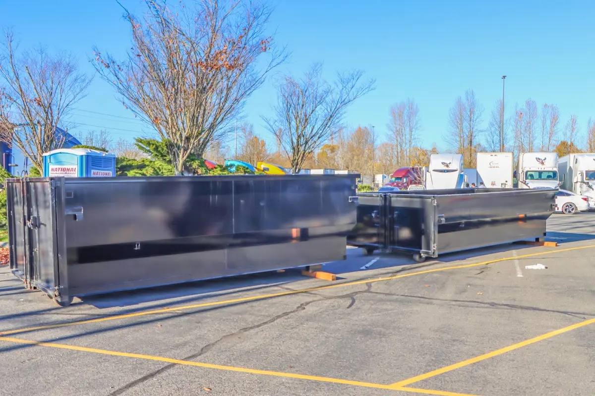 Professional dumpster rental service with roll-off container on residential driveway in Gallup